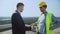 Young businessman and construction manager shaking hand, work agreement, service