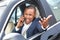 Young businessman driver sitting inside car driving answering phone call shouting unhappy hand outside side view close