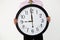 Young businessman with giant clock