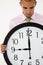 Young businessman with giant clock