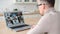 Young businessman in glasses has video call on the laptop