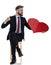 Young businessman holding big red heart and punching to side