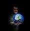 Young businessman holding in his hand a glowing earth globe