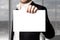 Young businessman holding white empty sign