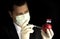 Young businessman injecting chemicals into an apple with Serbian