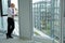 Young businessman looking thru window