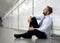 Young businessman lost in depression sitting on ground street subway