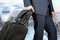 Young businessman in a modern stylish suit with luggage in