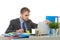 Young businessman overworked looking worried sitting at office computer desk in stress