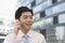 Young Businessman in pink button down shirt on the phone, Beijing, China