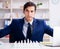 Young businessman playing glass chess in office