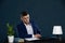 A young businessman reads a contract he is about to sign with a large financial consortium.