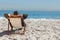 Young businessman relaxing on his sun lounger