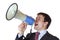 Young businessman shouts loudly at megaphone