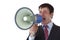 Young businessman shouts loudly into megaphone