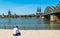 young businessman spending his time at the deutzer rhine boulevard in Cologne at summer