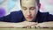 Young businessman stacking coins. Close up