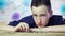 Young businessman stacking coins. Close up