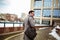 Young businessman standing in front of huge modern business building