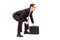 Young businessman in sumo wrestling stance holding suitcase