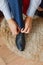 Young businessman ties shoes on a carpet.