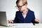 Young businessman using a laptop. Serious child in glasses