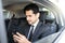 Young Businessman Using Smartphone In Car