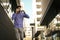 Young businessman walking trough street and drinking coffee.