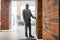 Young businessman wearing glasses standing near elevator