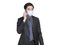 Young businessman wearing  protective mask, using  mobile phone to have  conversation. Coronavirus pandemic prevention concept