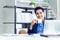 A young businessman wearing a suit and a long sleeve shirt inside and sitting smart poses has a feel happy smile in a modern