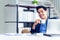 A young businessman wearing a suit and a long sleeve shirt inside and sitting smart poses has a feel happy smile in a modern