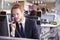 Young businessman at work in a busy, open plan office