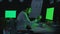 Young businessman working on computer with green monitor in night office.