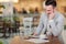 Young businessman working on a digital tablet in a cafe