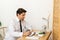 Young businessman working in office, sitting at desk