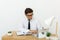 Young businessman working in office, sitting at desk