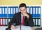 Young businessman writing a note at office