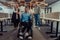 Young businessmen in a modern office extend a handshake to their business colleague in a wheelchair, showcasing