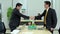 Young businessmen and senior businessmen are shake hand with the concept working together of traditional and modern things.