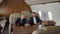 Young businessmen talking, sitting in airplane interior during flight.