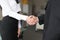 Young businesspeople handshake in office closeup