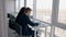 Young businesspeople working on business project sitting by window in modern office.