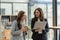 Young businesswoman and accountant talking with laptop and tablet Two attractive millennial