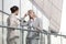 Young businesswoman arguing with female colleague at office railing