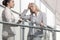 Young businesswoman arguing with female colleague at office railing