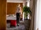 Young businesswoman arrives in a hotel room with red suitcase