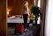 Young businesswoman arrives in a hotel room with red suitcase