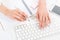 Young businesswoman with beautiful manicure typing on keyboard at workplace