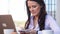 Young businesswoman on a coffee break using mobile phone.